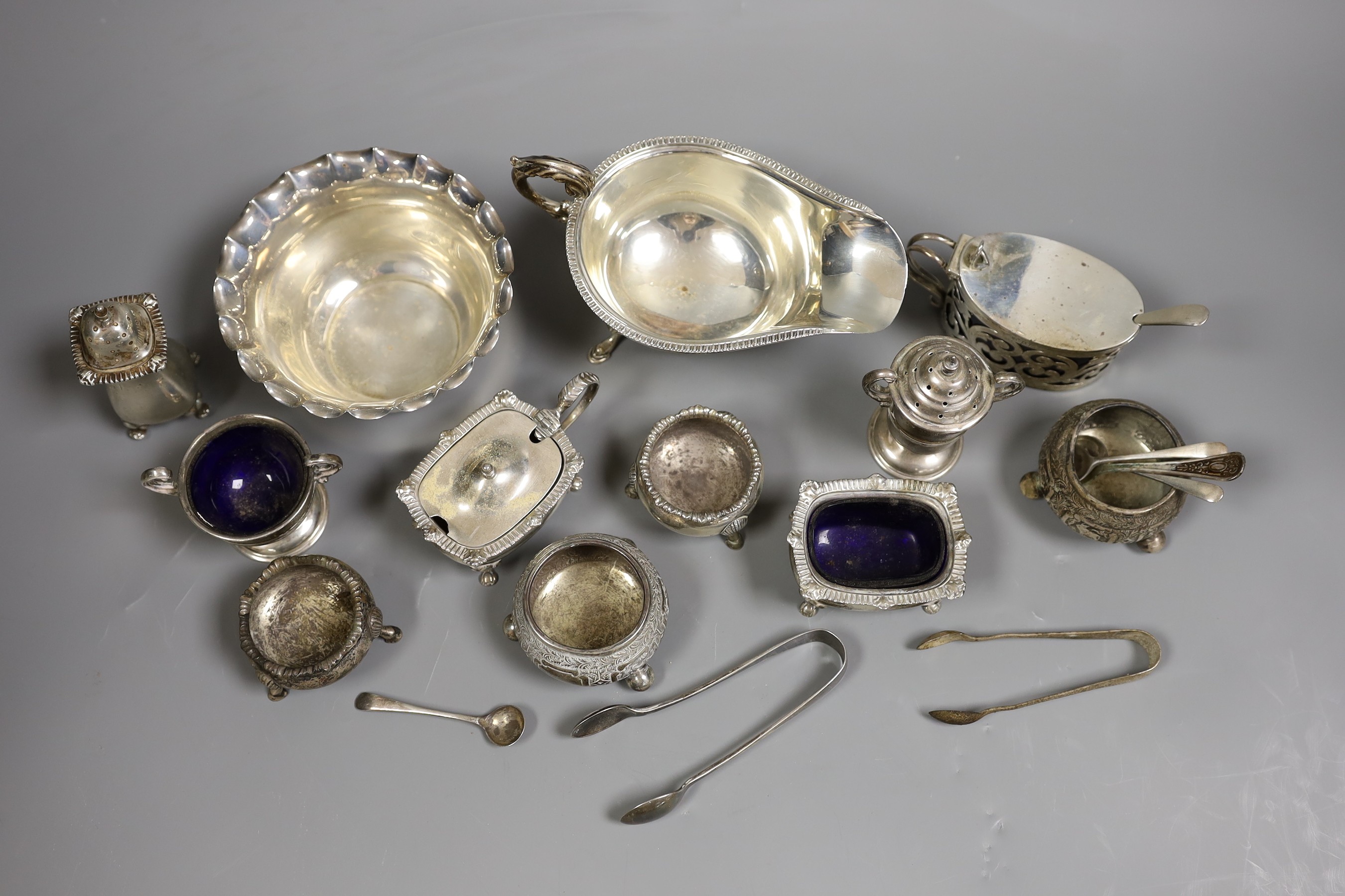 A small collection of mixed silver to include cased cutlery, a ladle, sauceboats, condiments, etc.